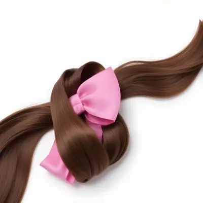 A Close Up Of Long Wavy Brown Hair With A Pink Hair Clip Or Accessory 9 0940