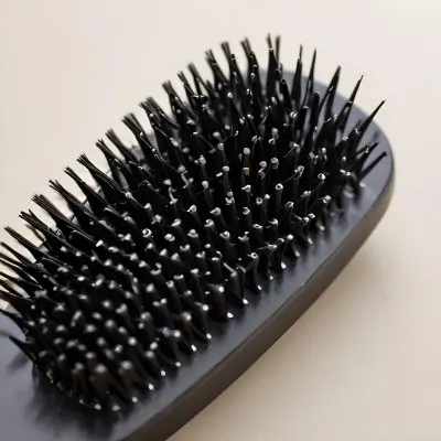 A Close Up View Of A Black Hair Brush With Dense Rigid Bristles 4 16dc