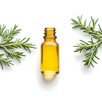 A Glass Bottle Filled With Yellow Essential Oil Surrounded By Sprigs Of Rosemary On A White Background 9 C2cf