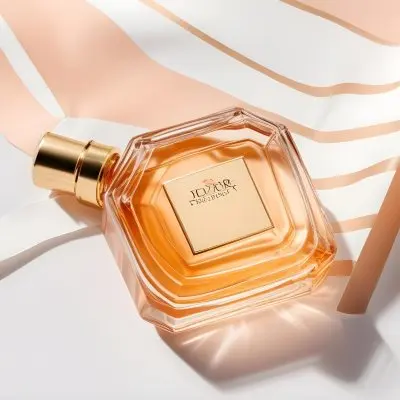 A Glass Bottle Of Perfume On A White Striped Background 8 7863