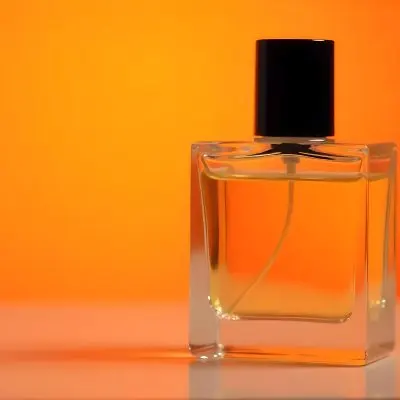 A Glass Bottle Of Perfume Or Cologne On An Orange Background 24 64d9