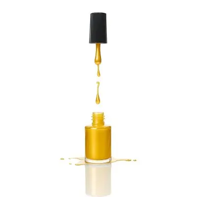A Golden Nail Polish Bottle With A Drop Falling Into It And The Brush Above It On A White Background 22 Cb09