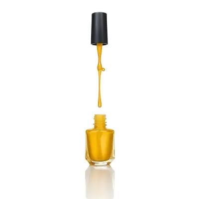 A Golden Nail Polish Bottle With A Drop Falling Into It And The Brush Above It On A White Background 43 8706
