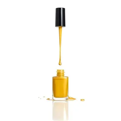 A Golden Nail Polish Bottle With A Drop Falling Into It And The Brush Above It On A White Background 6 9296