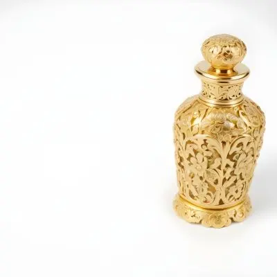 A Golden Ornate Perfume Bottle With An Intricate Floral Design 27 2803