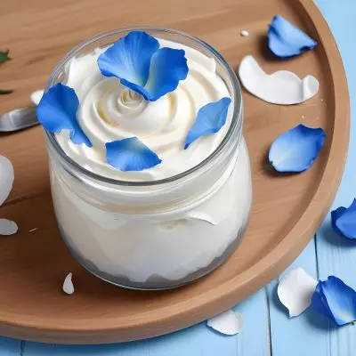 A Jar Of White Cream Surrounded By Blue Rose Petals On A Blue Plate White Wooden Table Background 3 0192