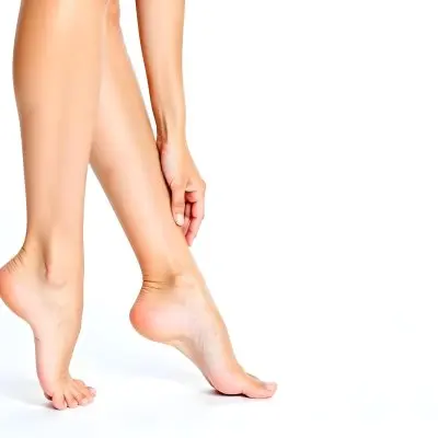 A Pair Of Fair Skinned Female Legs Around 25 Years Old With A Hand Touching The Ankle In A White Background 11 6bea