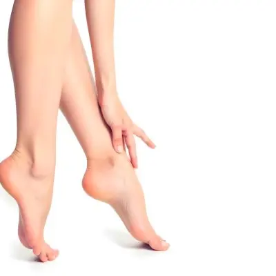 A Pair Of Fair Skinned Female Legs Around 25 Years Old With A Hand Touching The Ankle In A White Background 5 Eb2e