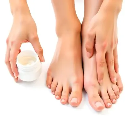 A Pair Of Woman S Feet With Fair Skin And A Hand Holding A White Jar With Cream On A White Background 17 9d9a
