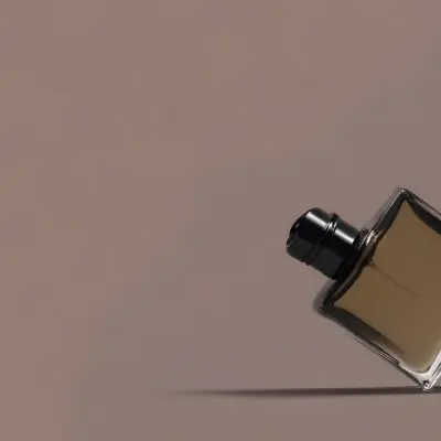 A Perfume Bottle With A Black Spray Nozzle On A Plain Black Background The Bottle Is Clear And Partially Filled With Liquid 15