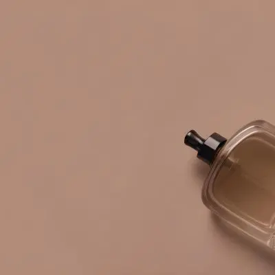 A Perfume Bottle With A Black Spray Nozzle On A Plain Black Background The Bottle Is Clear And Partially Filled With Liquid 2 Ab02