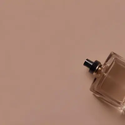 A Perfume Bottle With A Black Spray Nozzle On A Plain Black Background The Bottle Is Clear And Partially Filled With Liquid 25 Ed5a