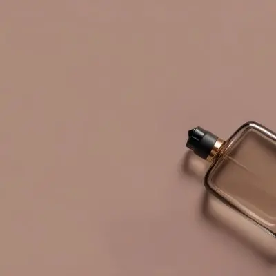 A Perfume Bottle With A Black Spray Nozzle On A Plain Black Background The Bottle Is Clear And Partially Filled With Liquid 28 879a