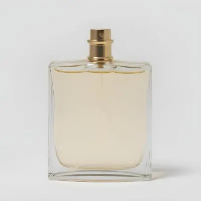 A Perfume Bottle With A Golden Cap And A Clear Glass Body Filled With A Clear Liquid On A White Background 22 59a3
