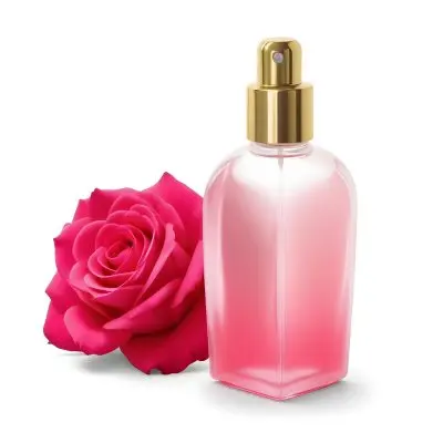 A Perfume Bottle With A Golden Cap Pink Liquid Inside Blurred Pink Flowers In The Background 16 8183