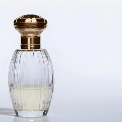 A Perfume Bottle With A Transparent Cap Transparent Glass With Vertical Stripes Half Full Of Transparent Liquid In A White Background 36 0747
