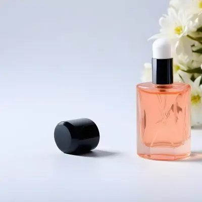 A Perfume Bottle With White Cap And Flowers In A Black Background 37 8a1d