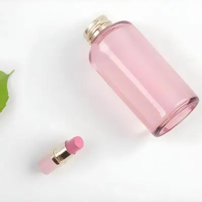A Pink Glass Bottle And A Pink Lipstick Tube On A White Background With A Green Leaf 3 B73d