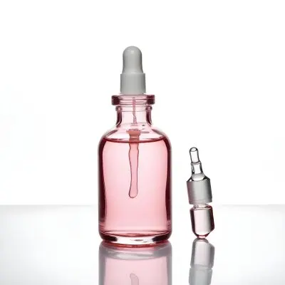 A Pink Glass Bottle With A Dropper Containing A Clear Liquid Serum Or Oil Product 12 1bae