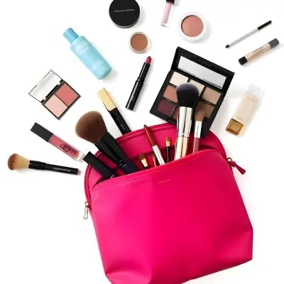 A Pink Makeup Bag Spilling Out Various Cosmetic Products Including Makeup Brushes Eyeshadow Palettes Lipsticks And Other Beauty Items On A White Background 8 28ea