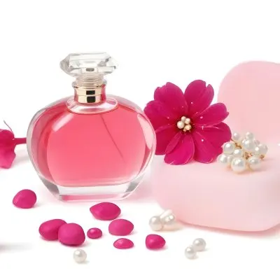 A Pink Perfume Bottle With A Glass Stopper A White Flower A White Soap And Some Pearls On A Pink Background 10 29da