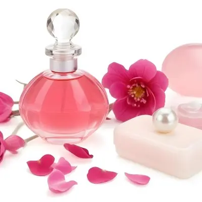 A Pink Perfume Bottle With A Glass Stopper A White Flower A White Soap And Some Pearls On A Pink Background 14 Aba6