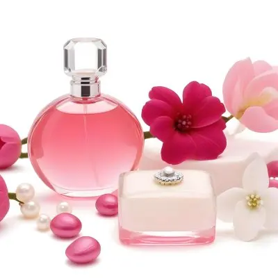A Pink Perfume Bottle With A Glass Stopper A White Flower A White Soap And Some Pearls On A Pink Background 25 1694