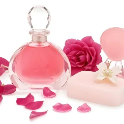 A Pink Perfume Bottle With A Glass Stopper A White Flower A White Soap And Some Pearls On A Pink Background 37 Adf2