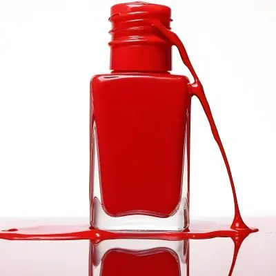 A Red Nail Polish Bottle With Nail Polish Dripping Down The Side On A Red Background 12 5137