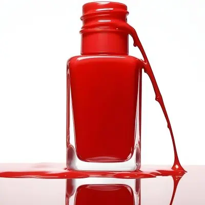 A Red Nail Polish Bottle With Nail Polish Dripping Down The Side On A Red Background 13 A6e6