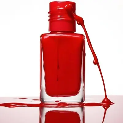 A Red Nail Polish Bottle With Nail Polish Dripping Down The Side On A Red Background 16 2c0e