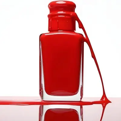 A Red Nail Polish Bottle With Nail Polish Dripping Down The Side On A Red Background 17 95da