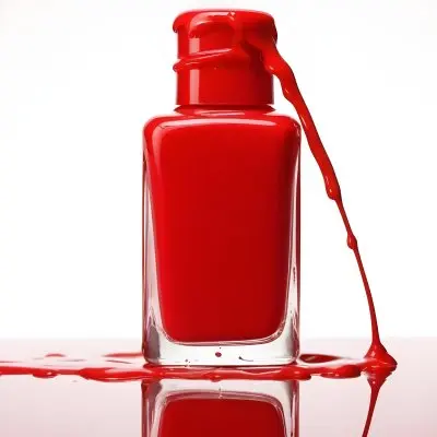 A Red Nail Polish Bottle With Nail Polish Dripping Down The Side On A Red Background 2 D932