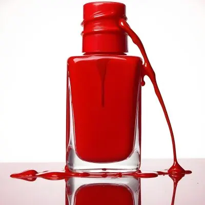 A Red Nail Polish Bottle With Nail Polish Dripping Down The Side On A Red Background 23 Fe40
