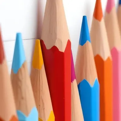 A Row Of Colored Pencils With Different Colors Red Yellow Blue Orange Pink On A Squared Paper Background 3 6794 05ad