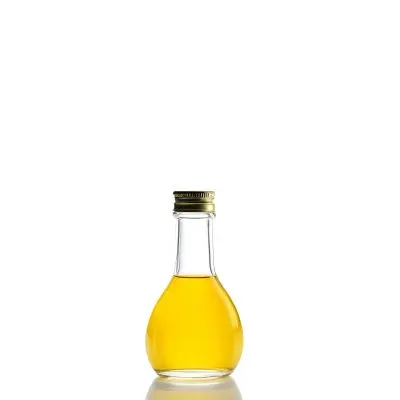 A Small Glass Bottle With A White Cap Filled With Yellow Liquid Isolated On A White Background Studio Shot Product Photography 4 45e3