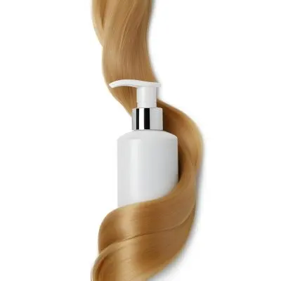 A White Bottle Of Shampoo With A Pump Wrapped In A Strand Of Long Blonde Hair On A White Background 5 84a4