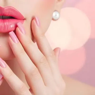 A White Woman Age 25 With Pink Lipstick And Pink Nails Posing With Her Hand Near Her Face In A Pink Bokeh Background 10 6f02
