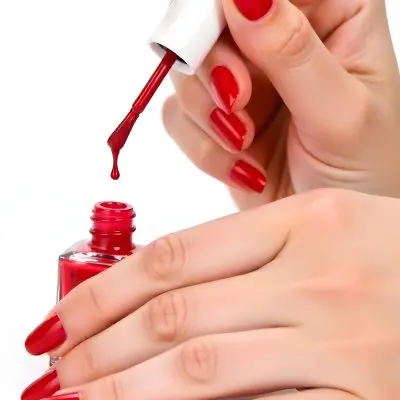 A Woman S Hands With Red Nail Polish One Hand Holding The Brush With A Drop Falling Into The Open Bottle White Background 14 2481