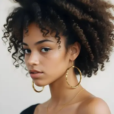 A Young African American Woman With Curly Dark Hair Wearing Gold Hoop Earrings And A Black Top 24 7d80