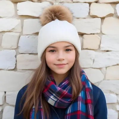 A Young Girl Approximately 12 Years Old With Light Skin And Long Brown Hair Wearing A White Beanie With A Pom Pom On Top And A Colorful Plaid Scarf The Background Consists Of A Textured Stone Wall 38 Da16