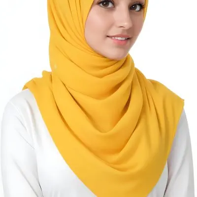 A Young Middle Eastern Woman With Dark Hair Wearing A Bright Yellow Hijab Smiling At The Camera 20 1ab6