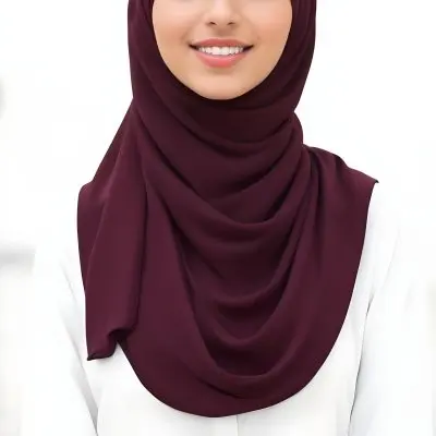 A Young Middle Eastern Woman With Dark Hair Wearing A Burgundy Hijab Smiling At The Camera 12 8898