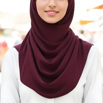 A Young Middle Eastern Woman With Dark Hair Wearing A Burgundy Hijab Smiling At The Camera 18 08e2