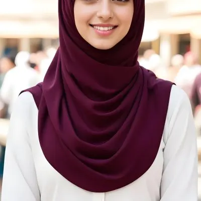 A Young Middle Eastern Woman With Dark Hair Wearing A Burgundy Hijab Smiling At The Camera 6 80a6