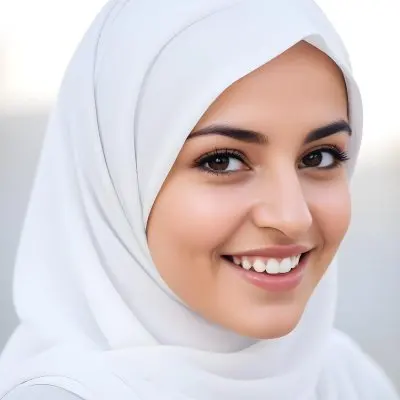 A Young Middle Eastern Woman With Dark Hair Wearing A White Hijab Smiling At The Camera 5 E660