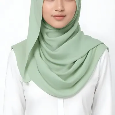 A Young Woman With Light Skin Brown Eyes And Long Dark Hair Wearing A Green Hijab And A White Shirt 13 33a0