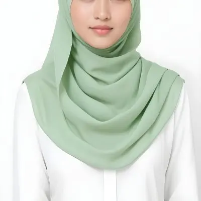 A Young Woman With Light Skin Brown Eyes And Long Dark Hair Wearing A Green Hijab And A White Shirt 17 7644