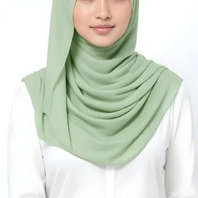 A Young Woman With Light Skin Brown Eyes And Long Dark Hair Wearing A Green Hijab And A White Shirt 21 3c5b