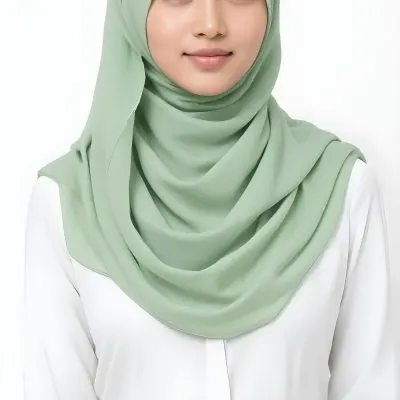 A Young Woman With Light Skin Brown Eyes And Long Dark Hair Wearing A Green Hijab And A White Shirt 7 3188